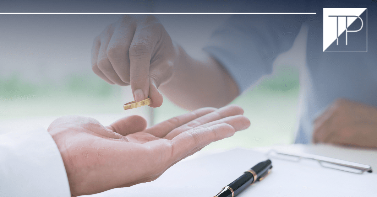 someone placing ring in hand of another