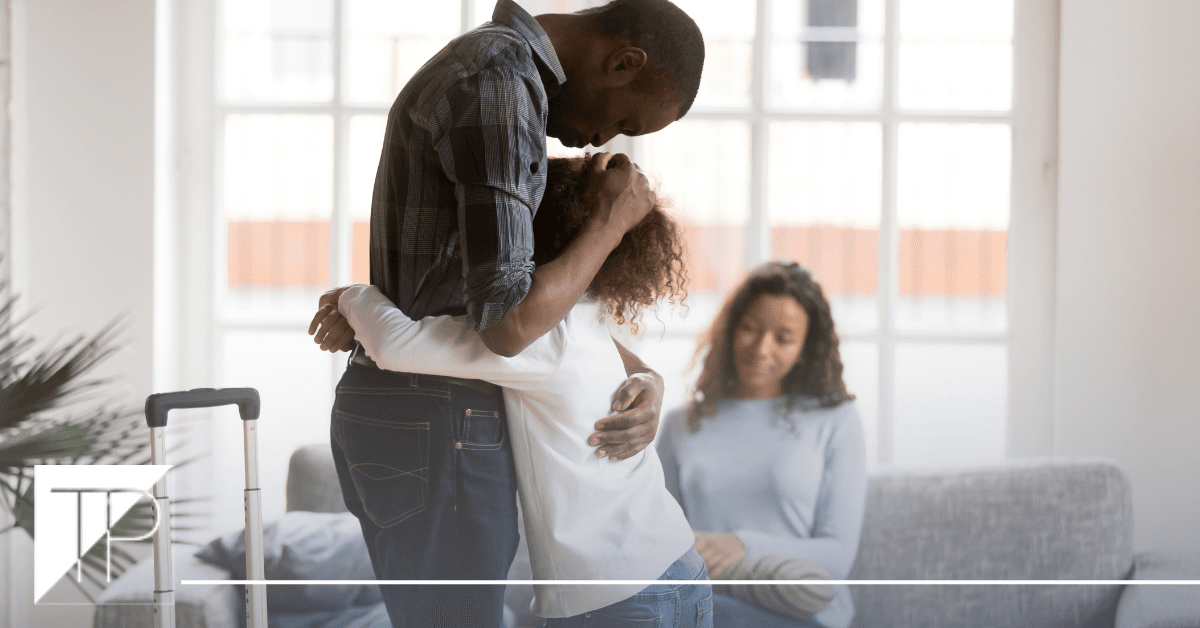 dad hugging daughter in front of mom
