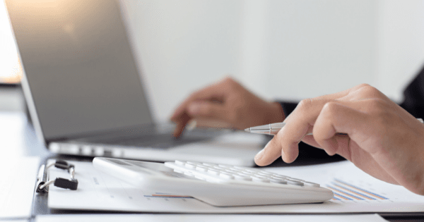 accountant typing on calculator