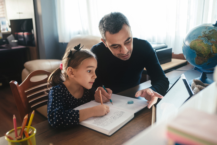 father helping daughter with homework