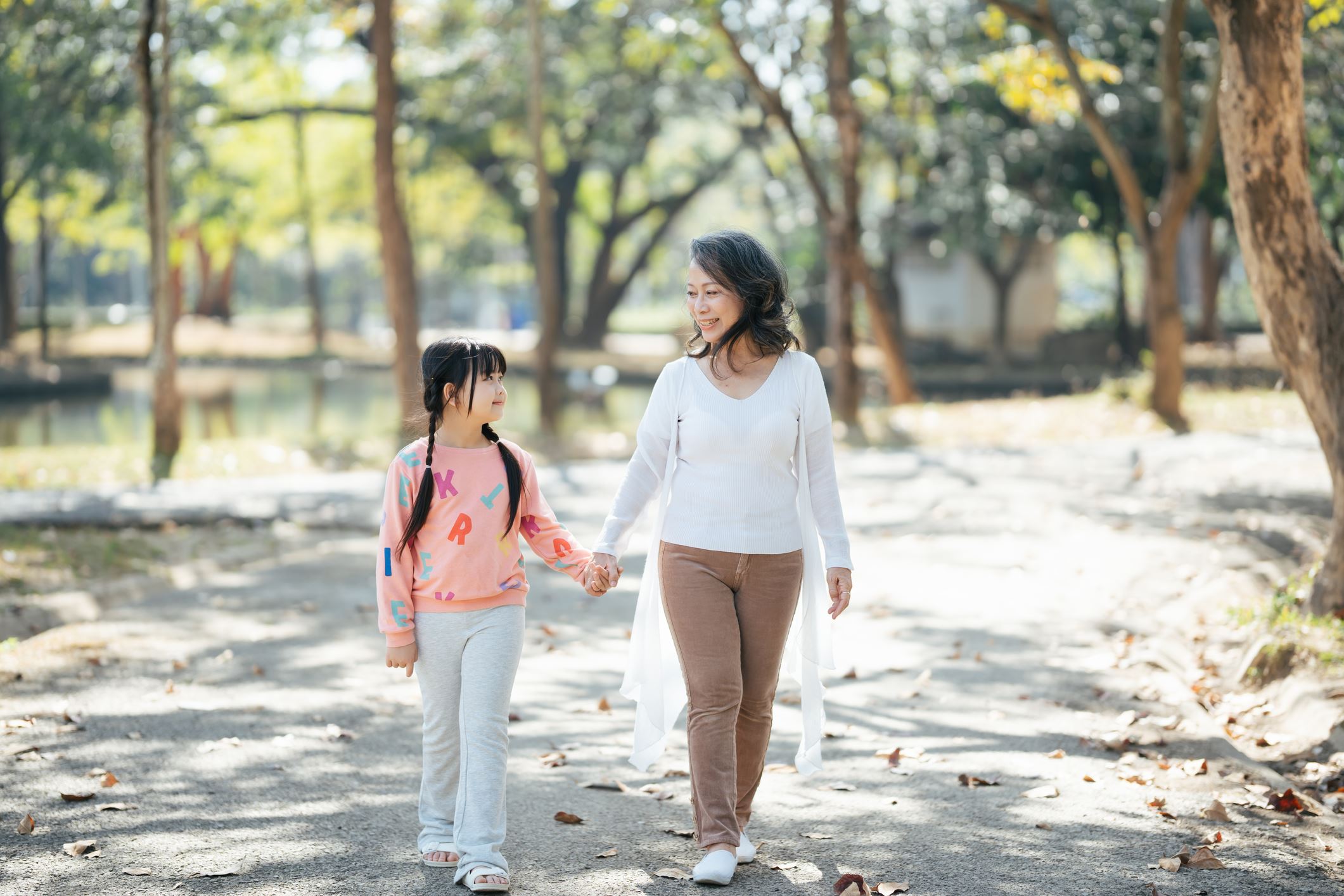 Mother and daughter walk in the park during the day
