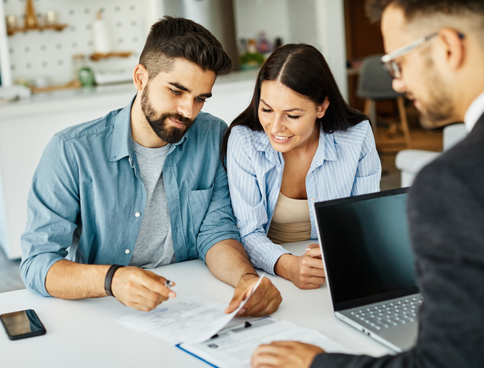 couple going through documents with a lawyer